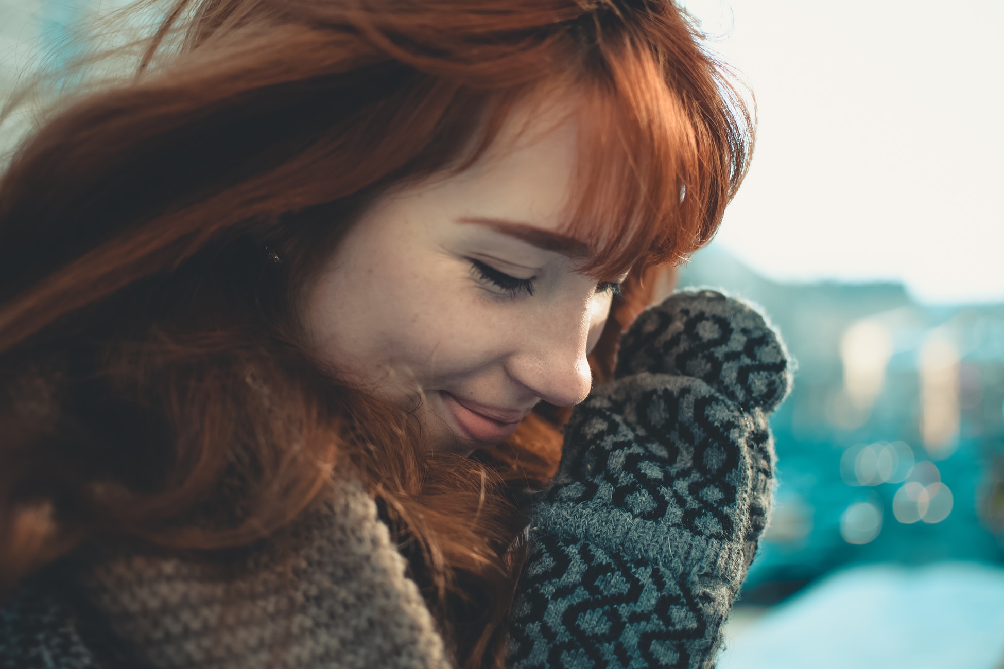 Young woman with mittens, looking smitten.