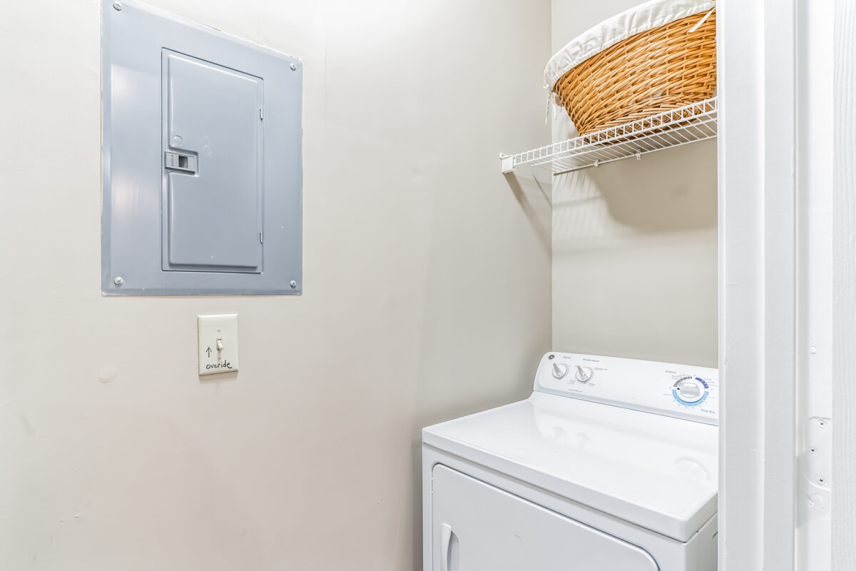 Laundry area with white washing machine