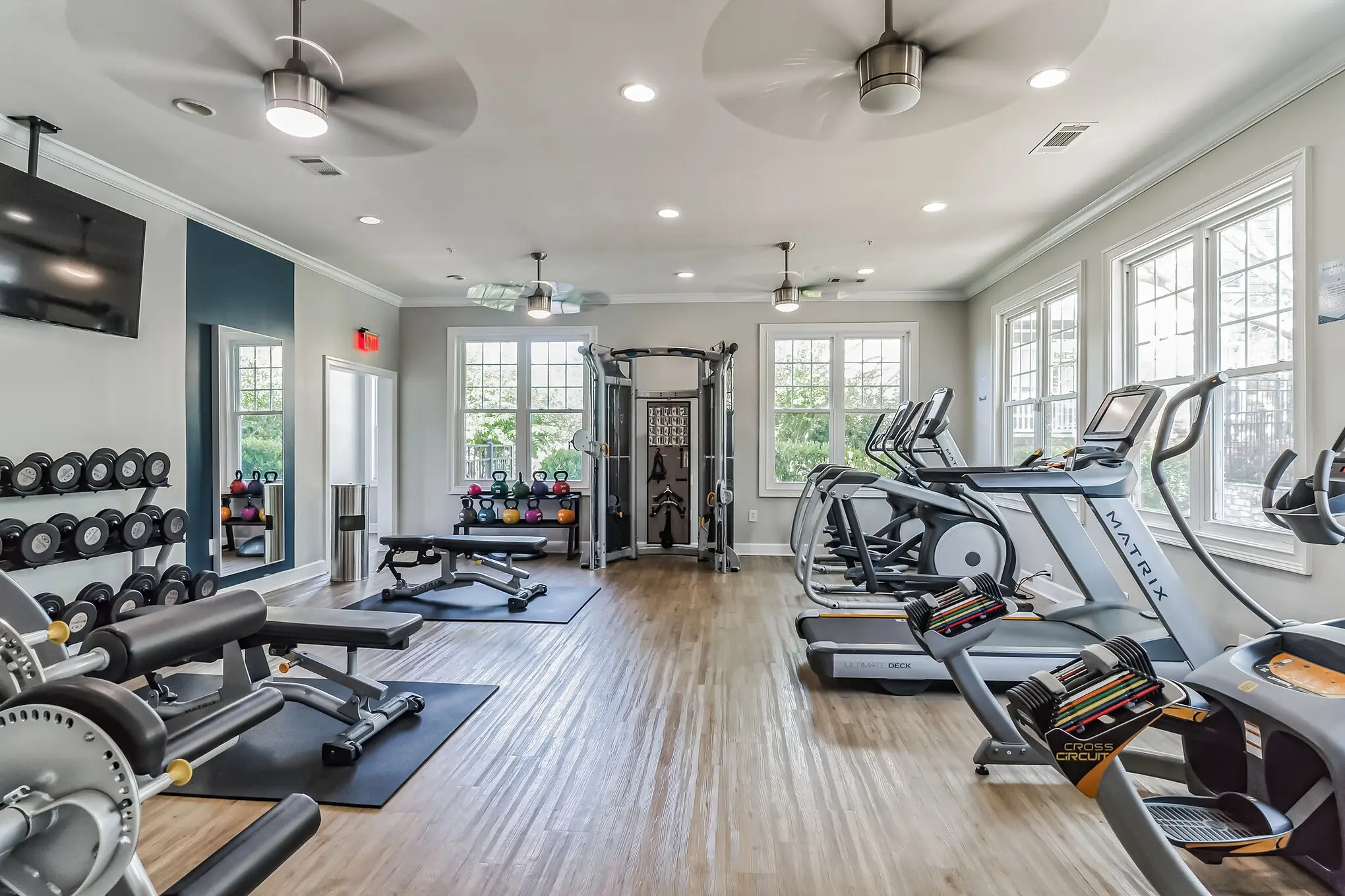 Fitness center with treadmills, elliptical cycles and weight benches.